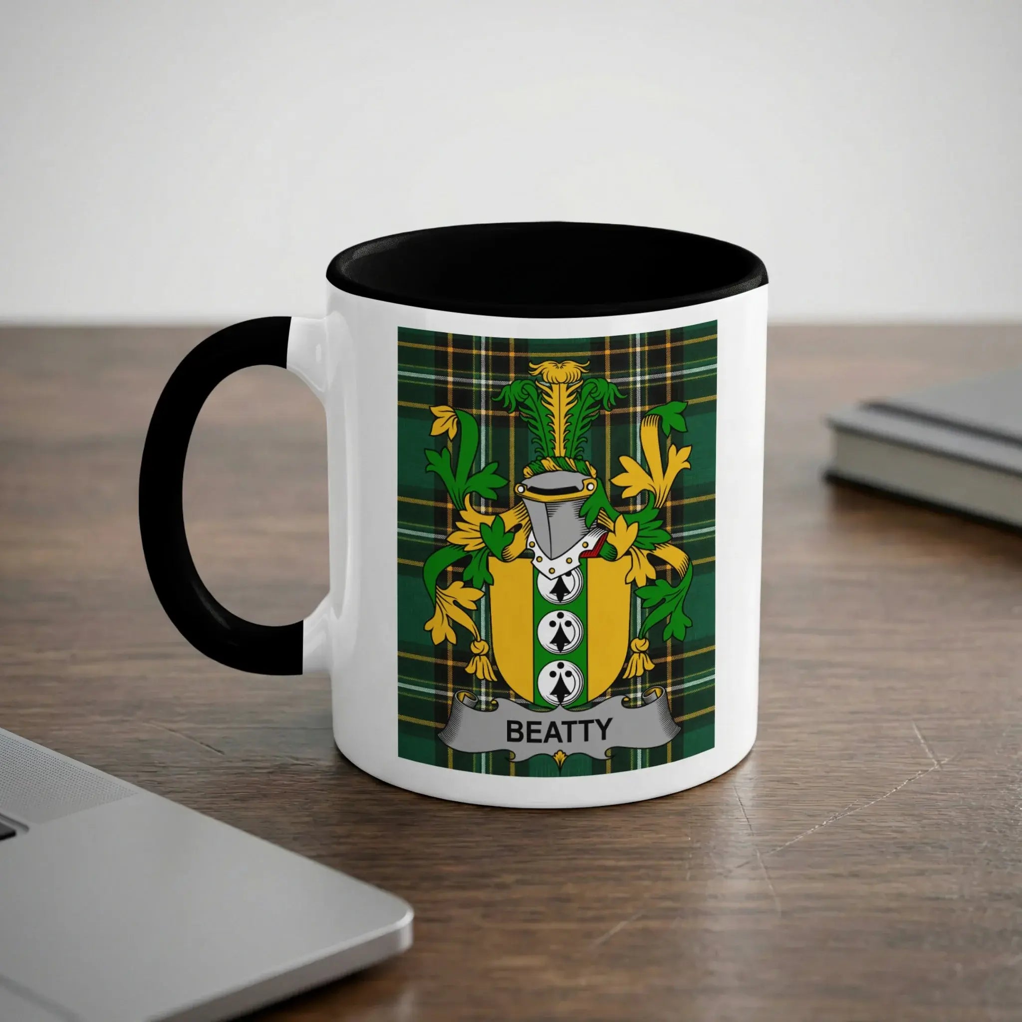White mug with black handle featuring the Beatty family crest against a tartan background.