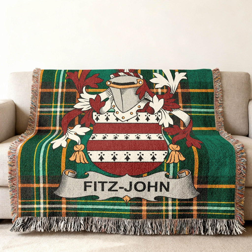 Fitz-John family crest on a green plaid throw blanket.