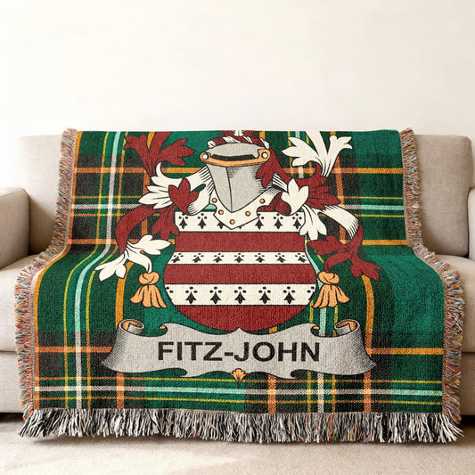 Fitz-John family crest on a green plaid throw blanket.