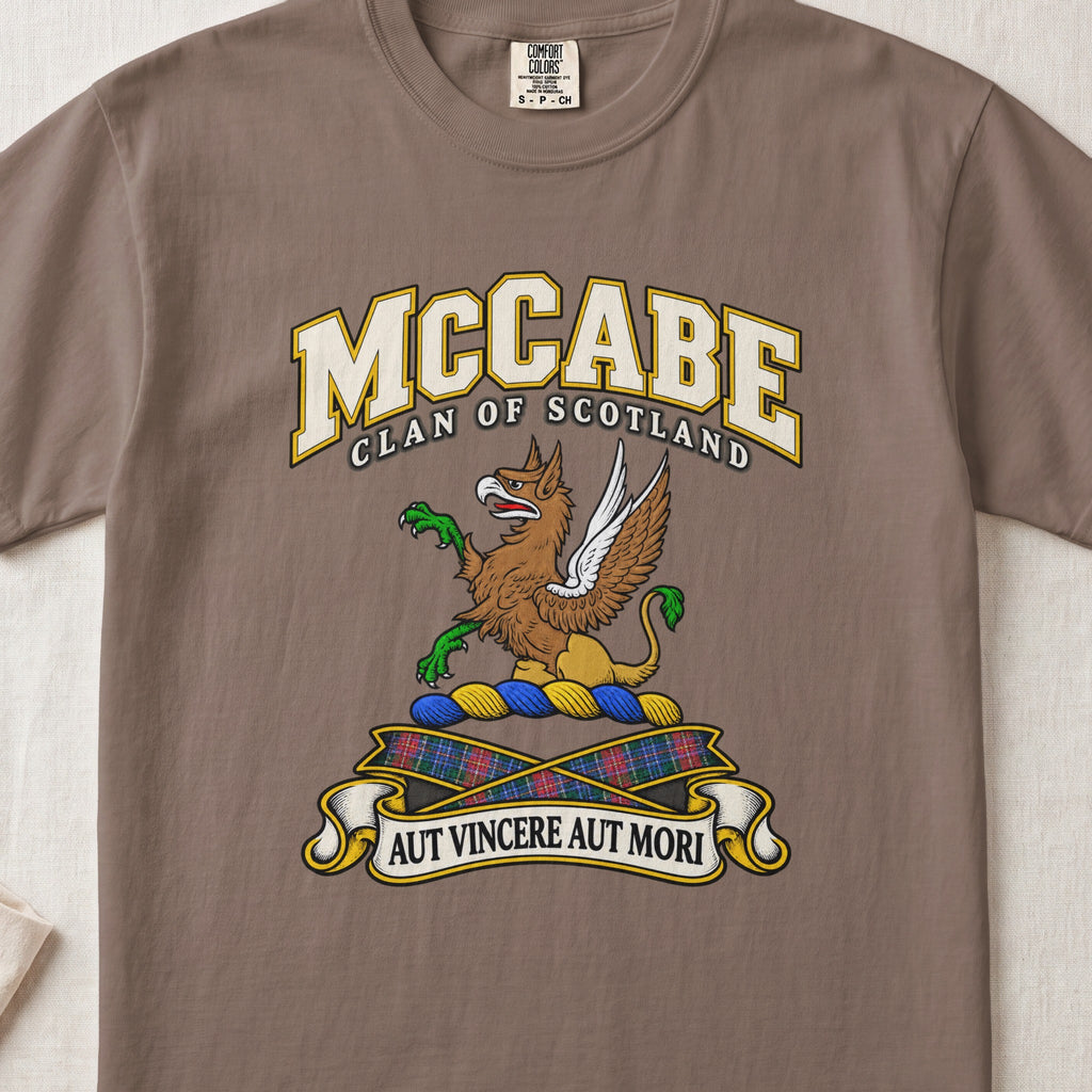 McCabe Scottish clan T-shirt in Espresso, front view with a brown and gold winged griffin with green claws and motto banner.