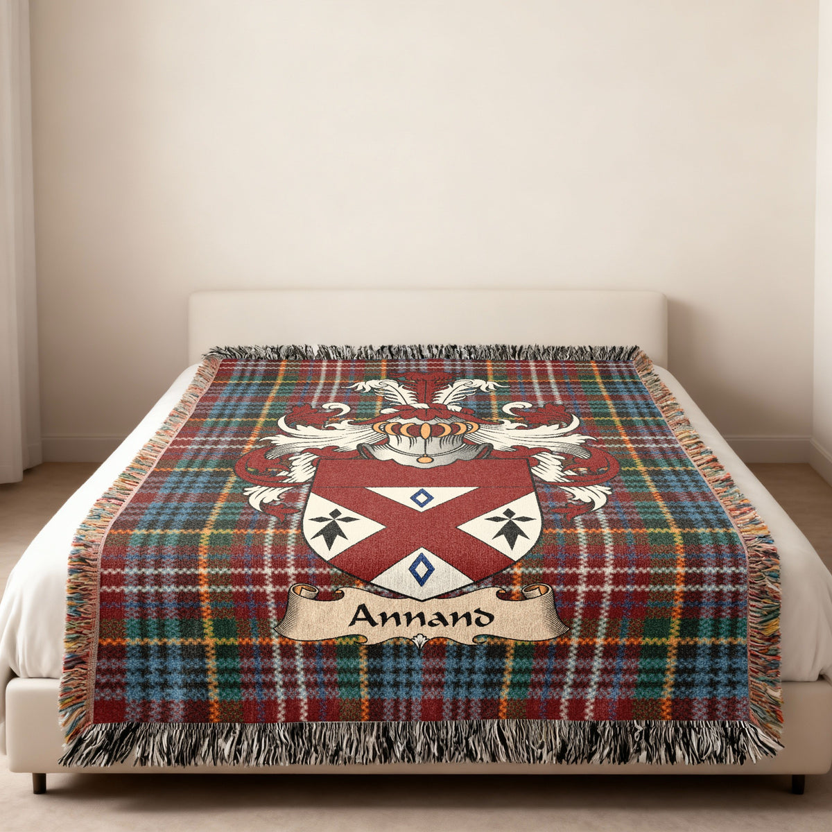 Annand family crest emblem on a Caledonia tartan woven blanket