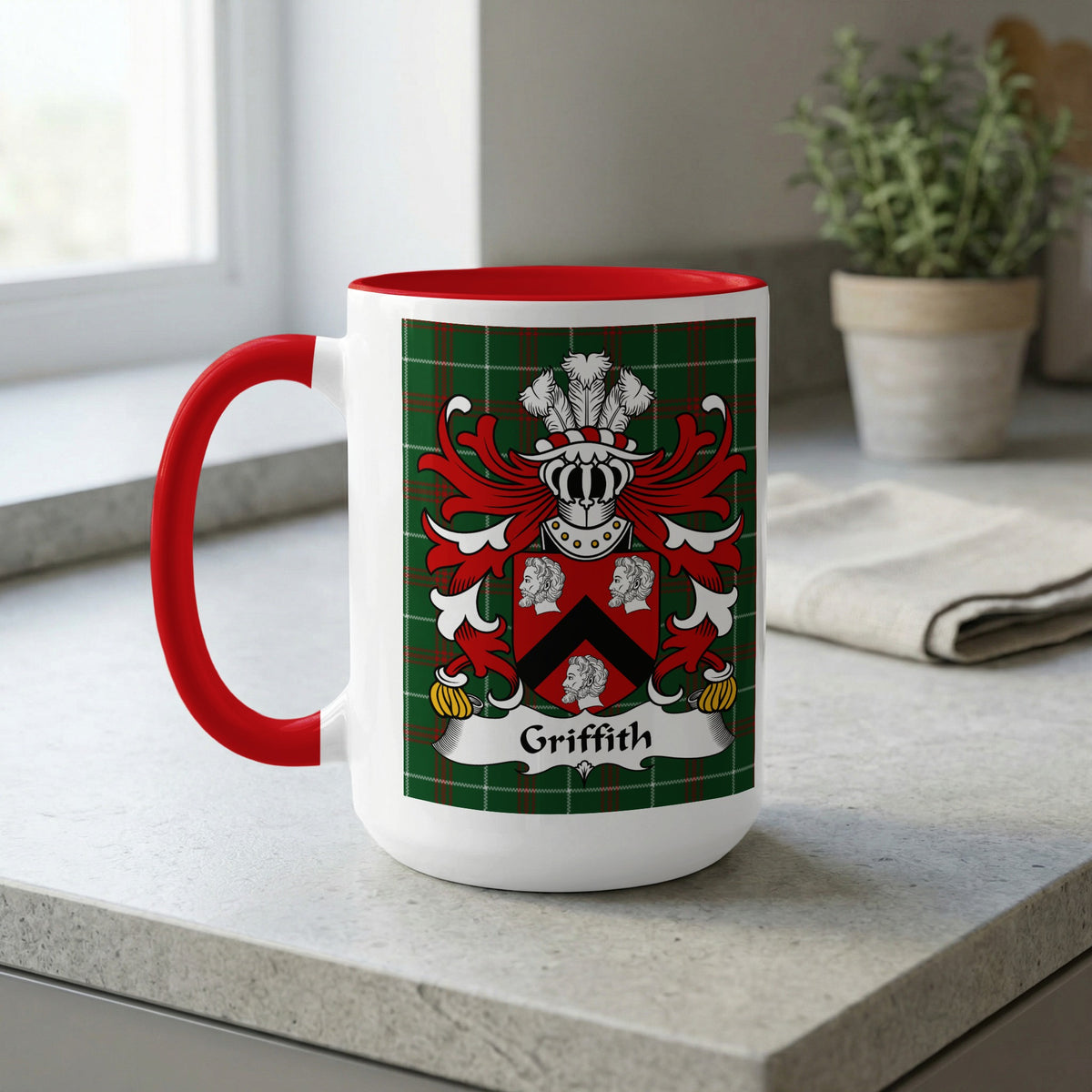White mug with red handle, featuring the Griffith family crest on a green tartan background.