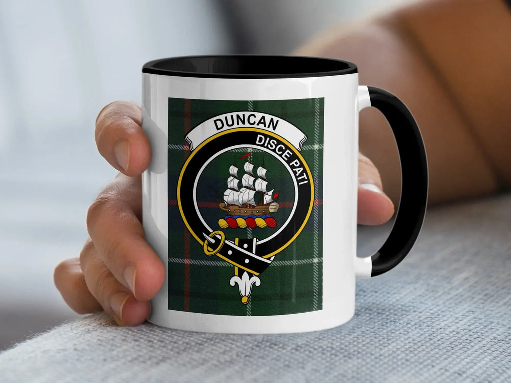White mug with black rim featuring Scottish clan crest and tartan design.