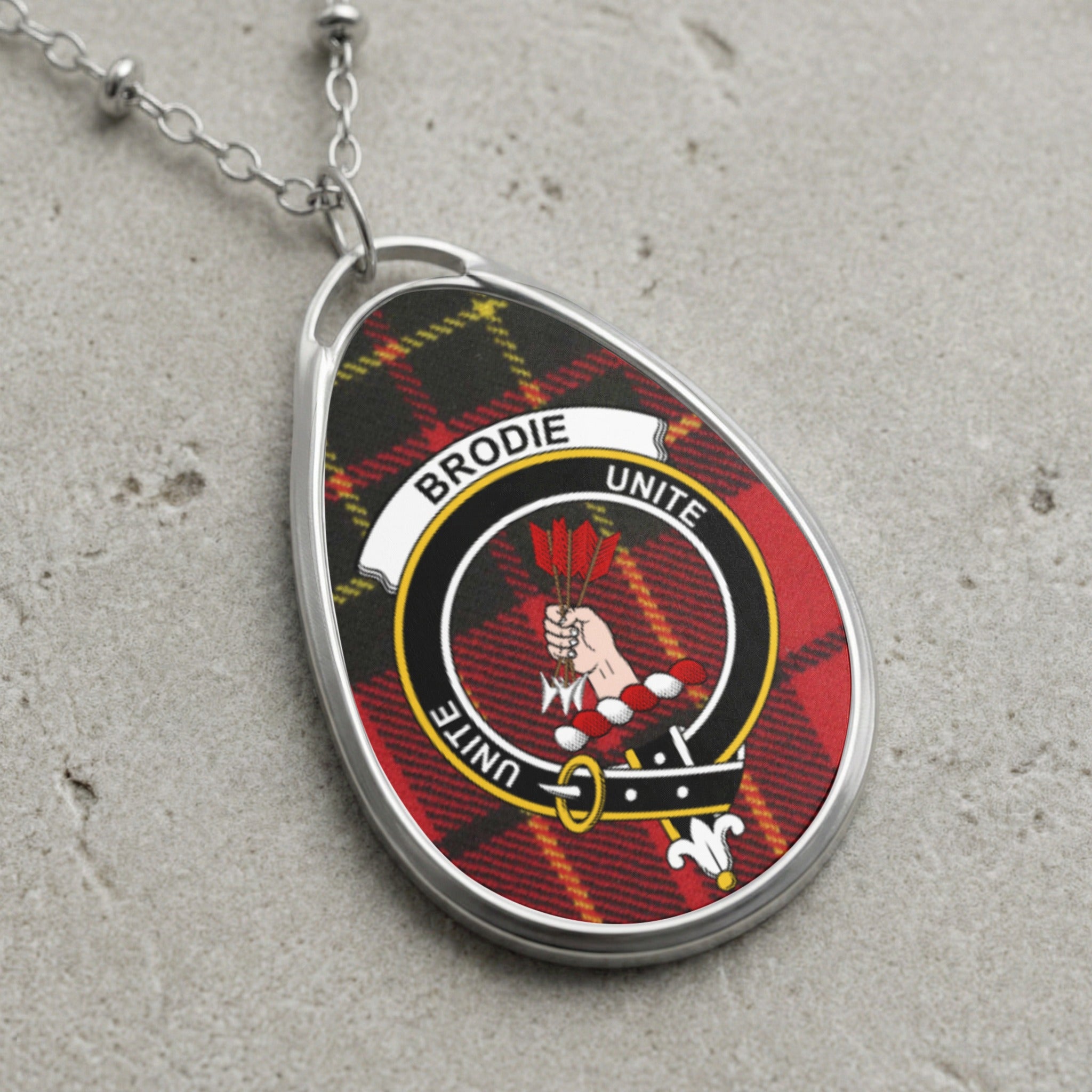 Brodie clan Scottish tartan necklace with clan crest on tartan background