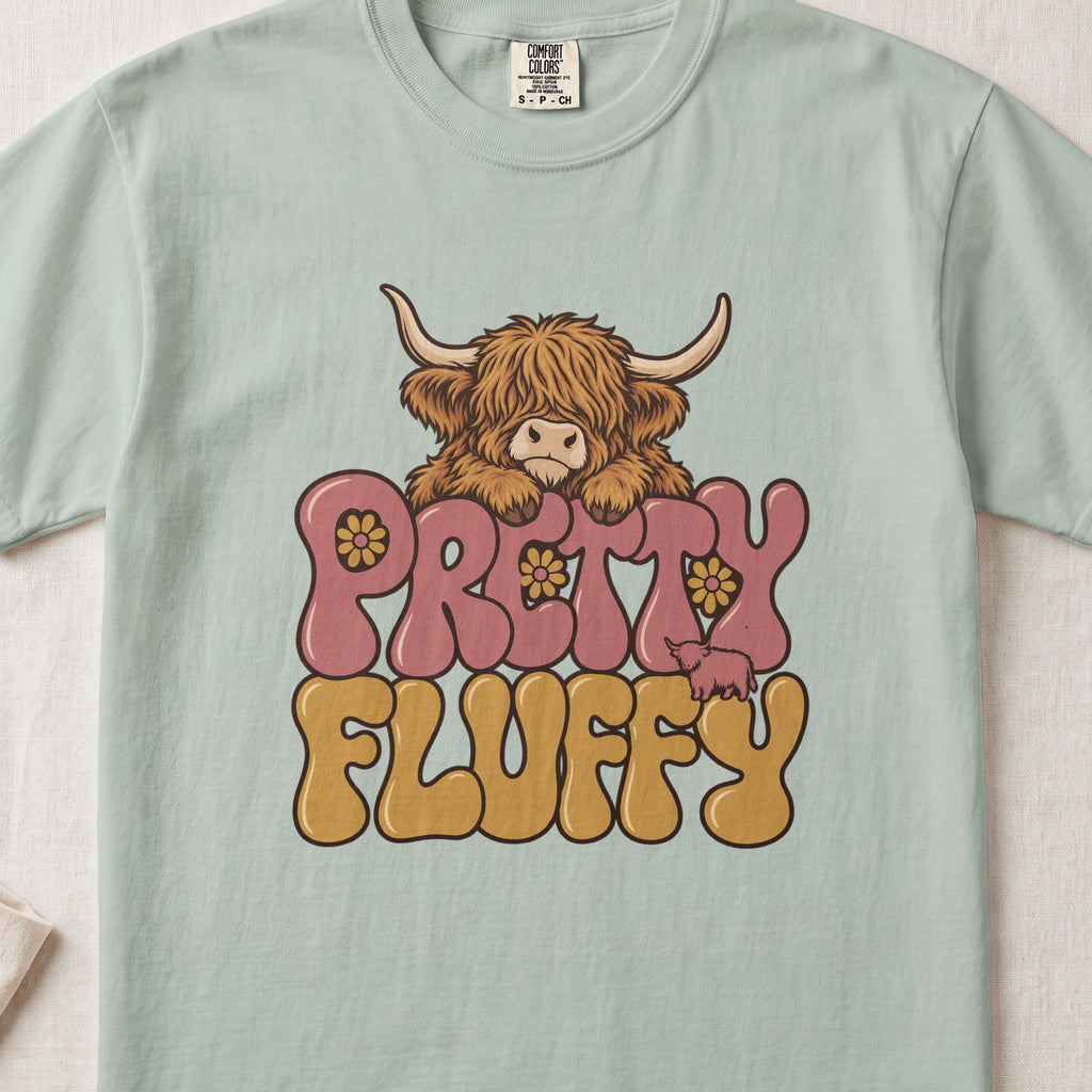 Pretty Fluffy Highland cow design on a Bay Comfort Colors 1717 T-shirt, flat lay