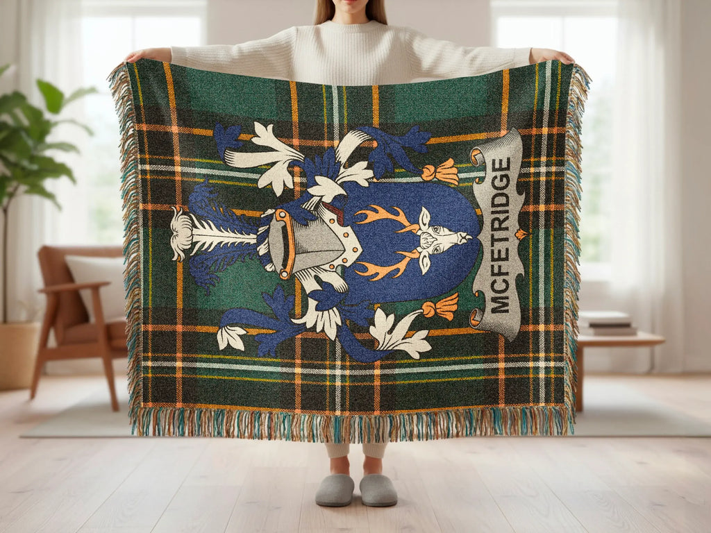 Tartan blanket with McFetridge crest, held by a person.