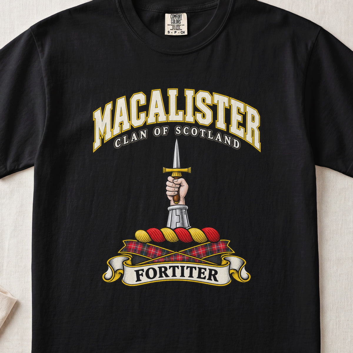MacAlister Scottish clan T-shirt in Black, front view with an armored arm and hand holding an upright dagger and motto design.