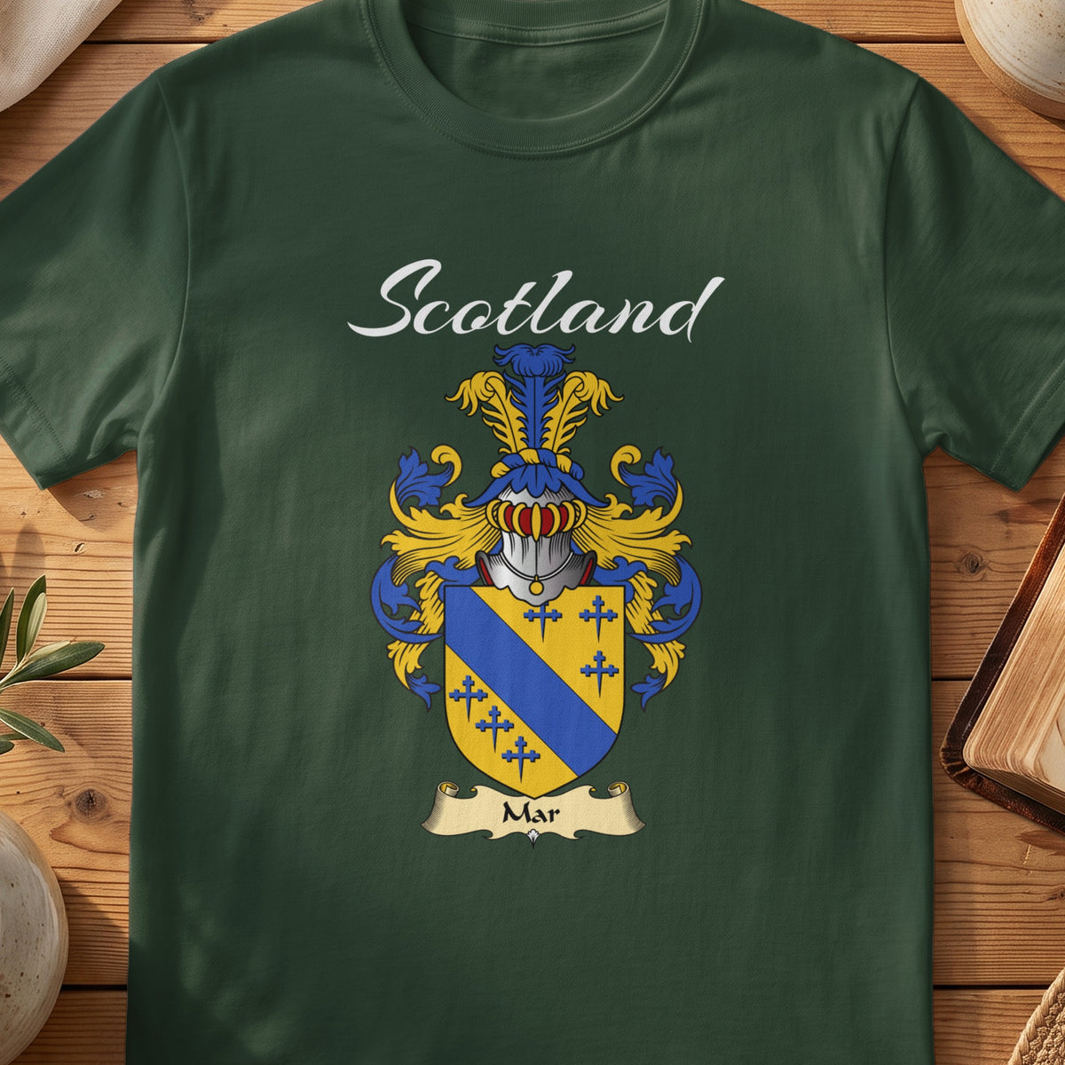 Forest Green Mar Scottish T-shirt featuring a gold shield crossed by a blue diagonal band