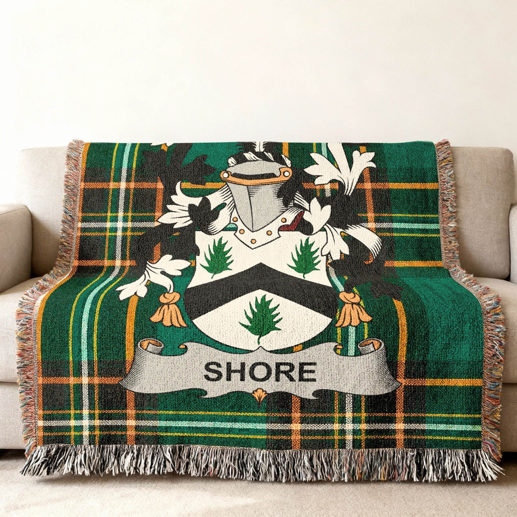 Green tartan throw blanket with the Shore family crest.