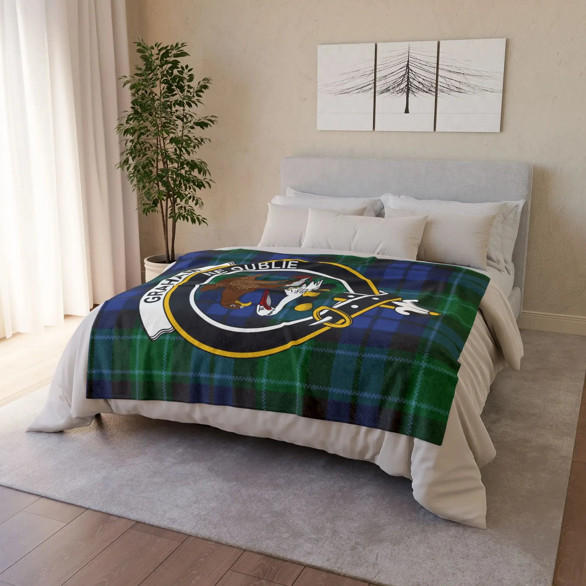 Graham tartan printed throw blanket draped on bed — falcon crest and Ne Oublie, hemmed edges