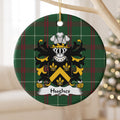 Hughes Style 1 ornament hanging from a pale wooden branch; a gold chevron and three gold fleurs-de-lis on a black shield on Welsh national tartan.