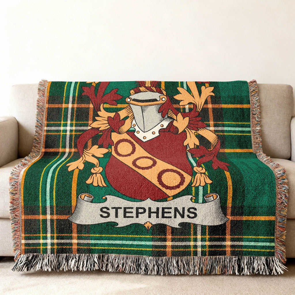 Green tartan blanket with Stephens family crest draped over a sofa.