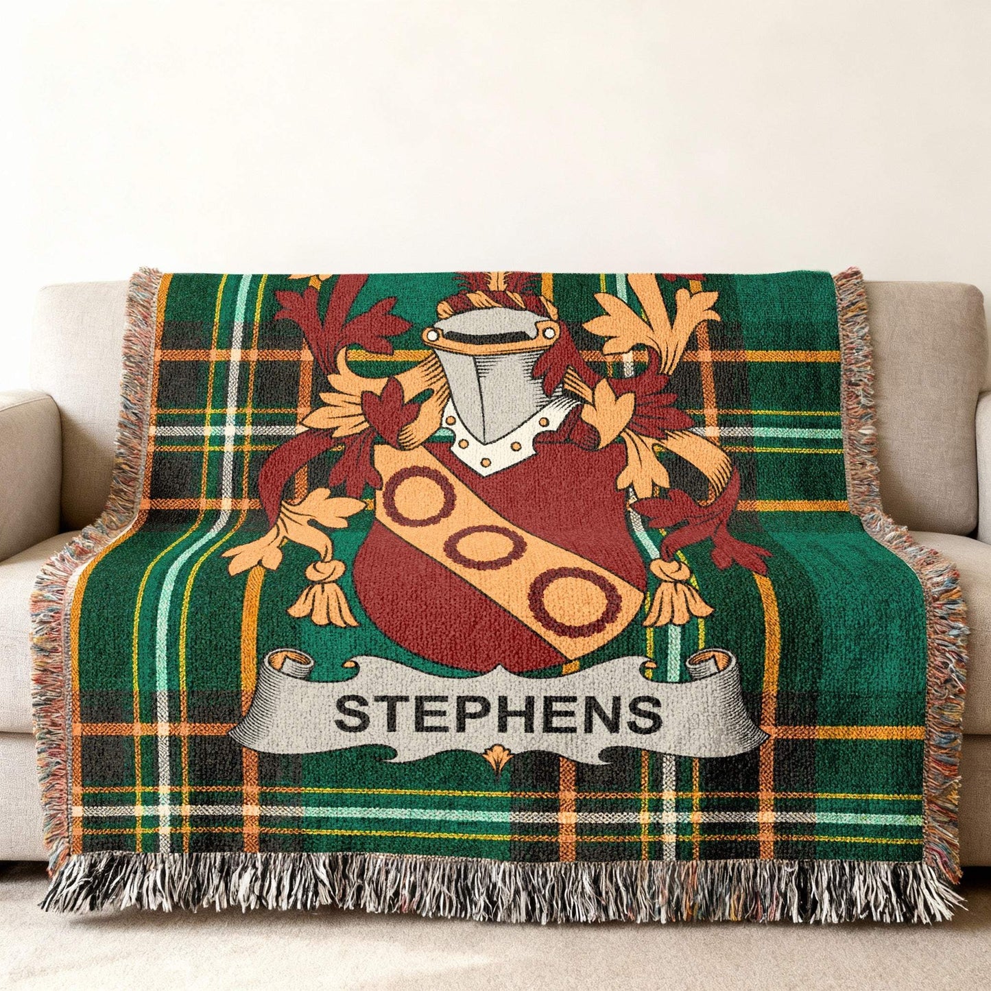 Green tartan blanket with Stephens family crest draped over a sofa.