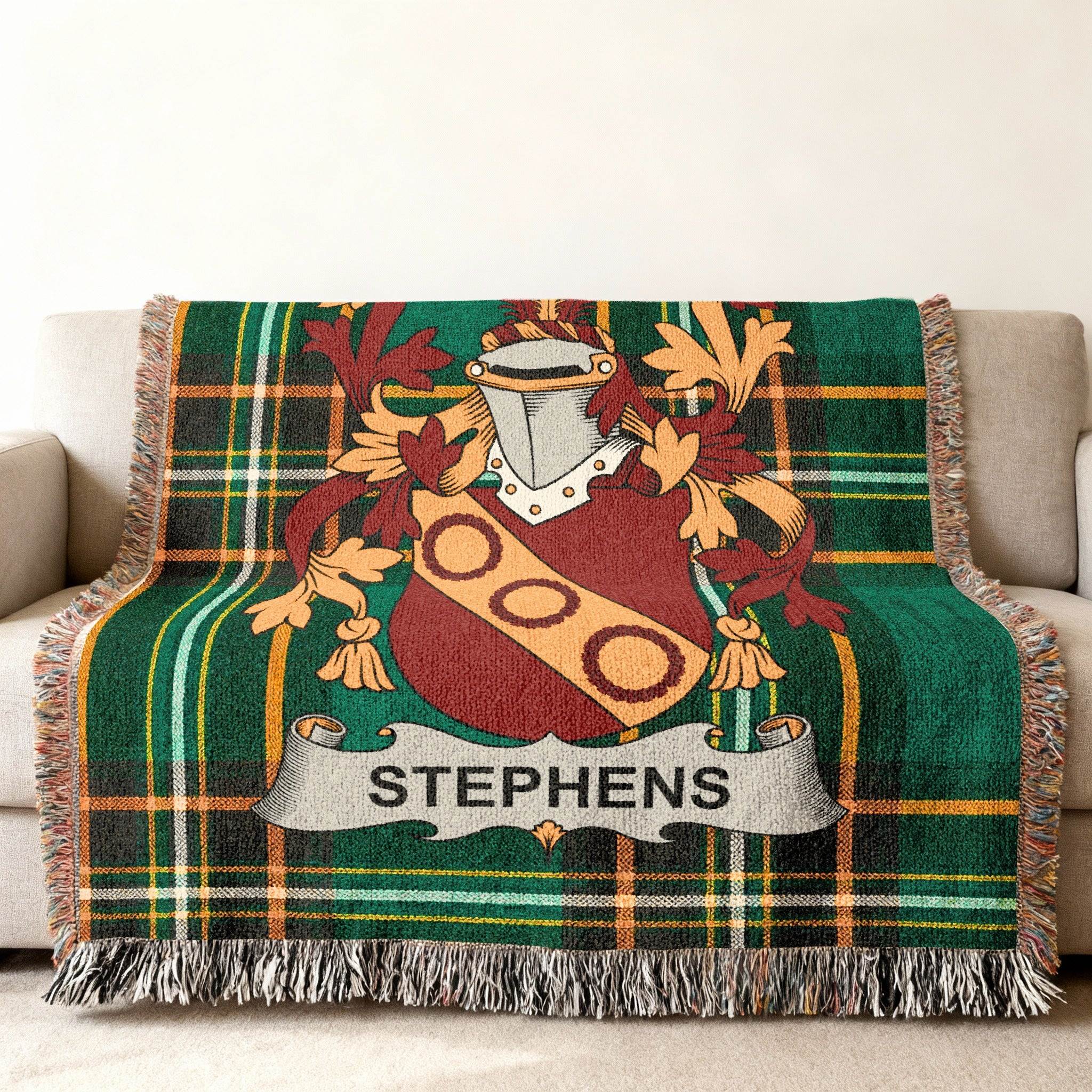 Green tartan blanket with Stephens family crest draped over a sofa.