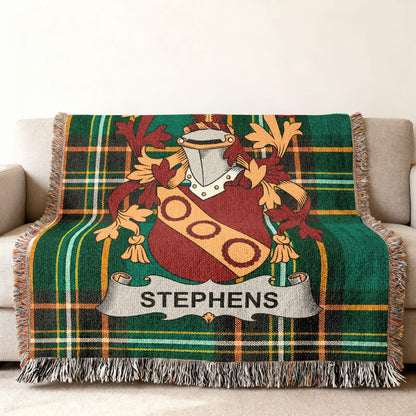 Green tartan blanket with Stephens family crest draped over a sofa.