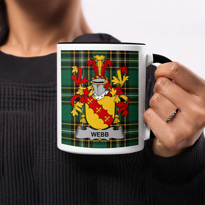 Black mug with Webb family crest on green plaid background.