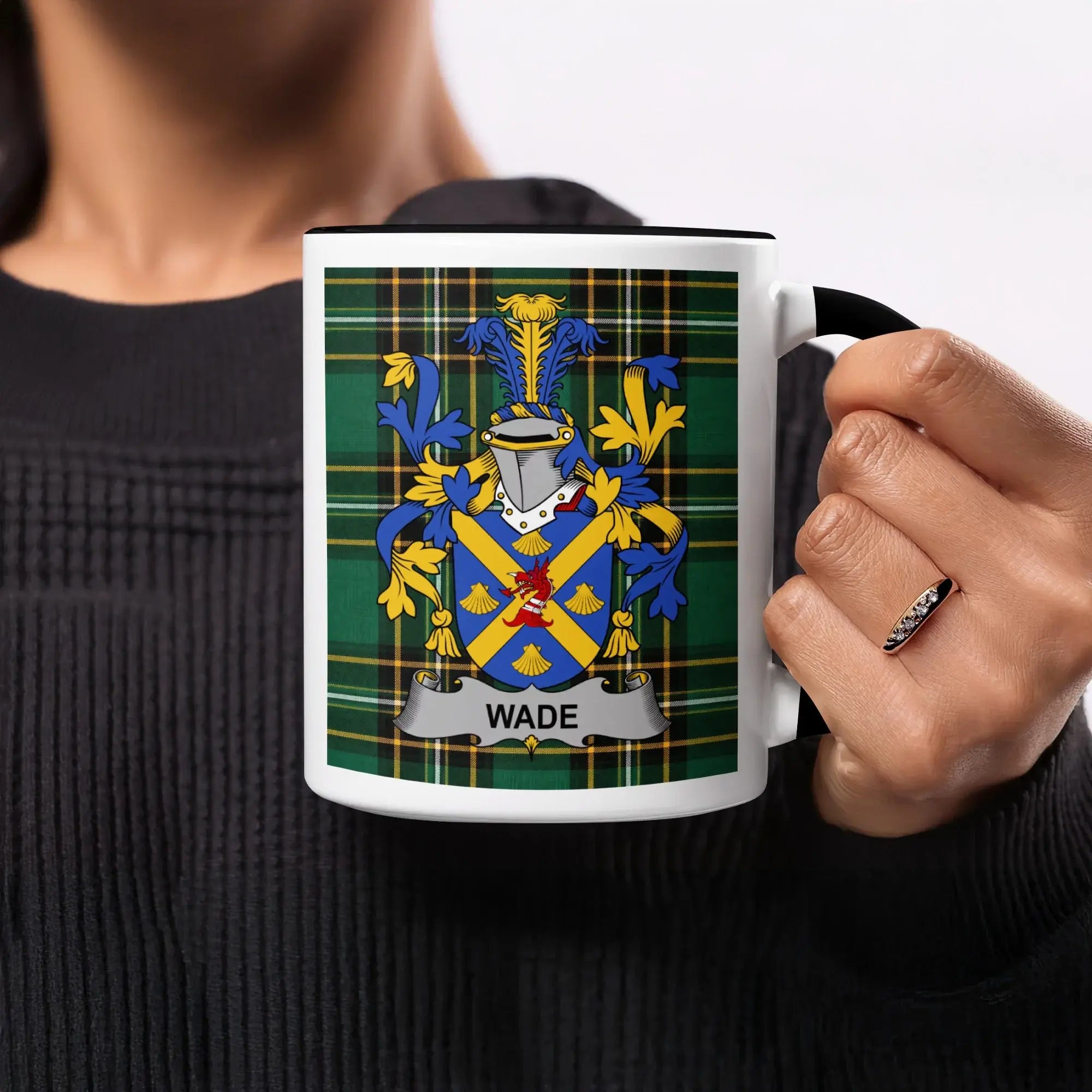 White mug with black handle featuring a green plaid background and the Wade family crest.