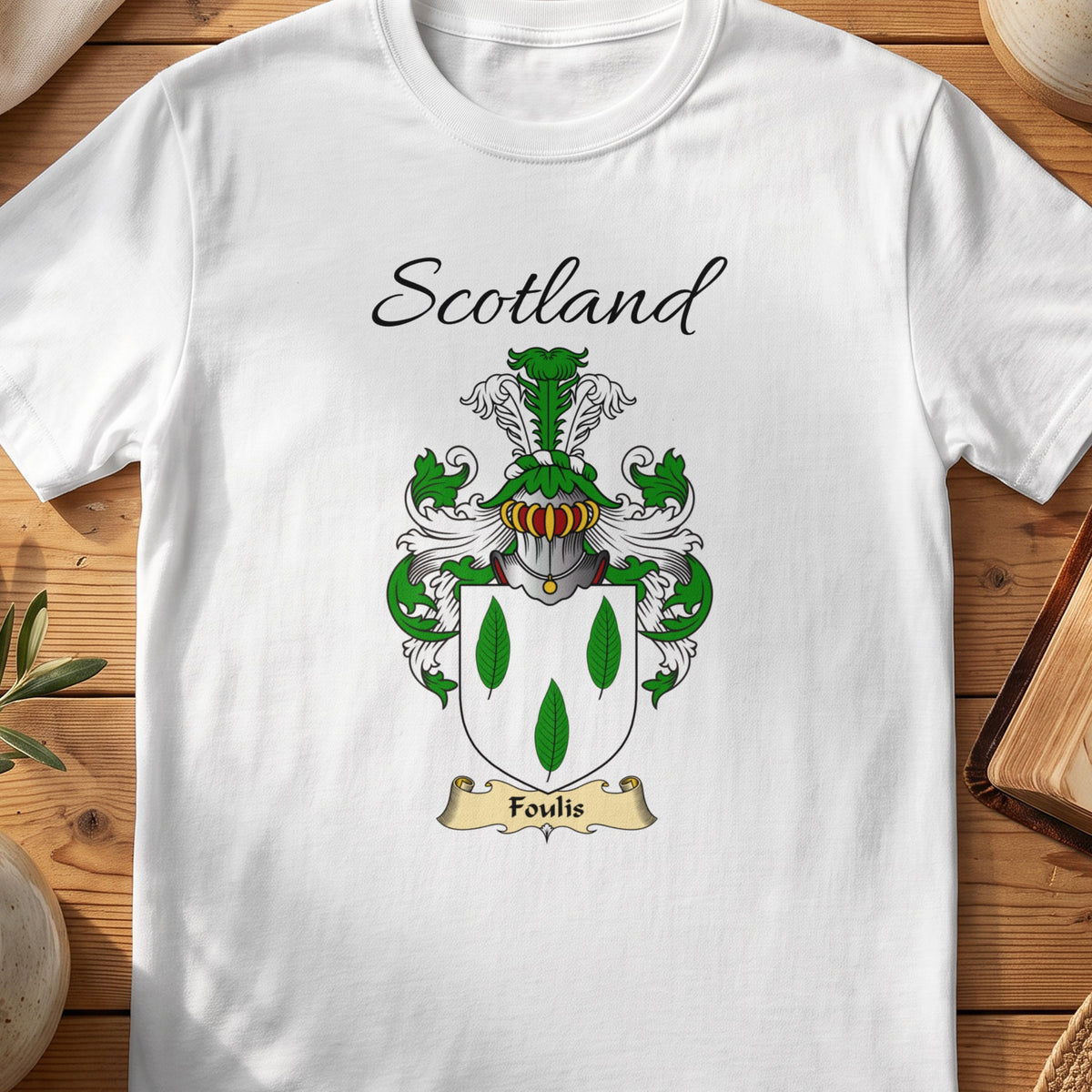 White Foulis Scottish family shield T-shirt featuring three green leaf shapes on white