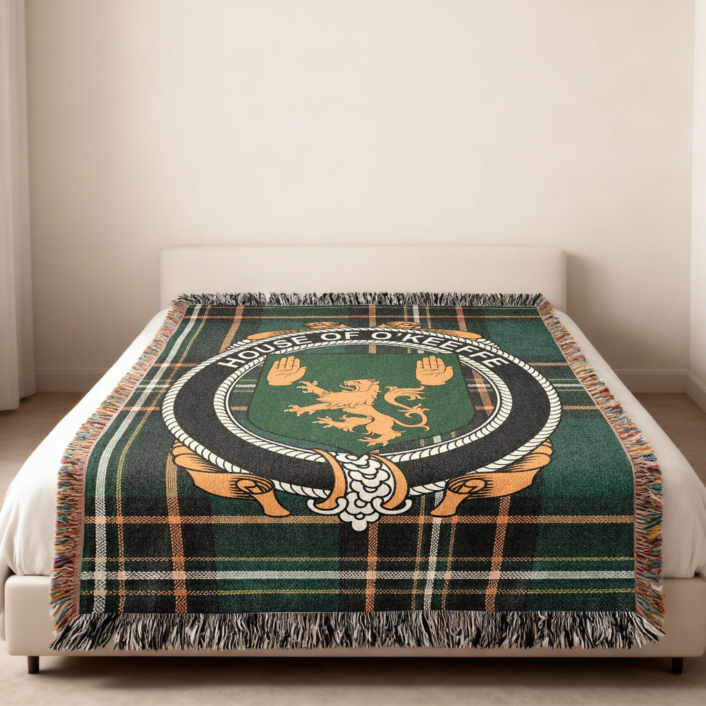 O'Keeffe family crest emblem woven blanket displayed on a bed