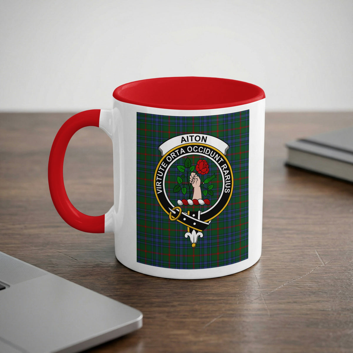 Aiton Scottish family crest artwork on an 11 oz red accent mug with a tartan background