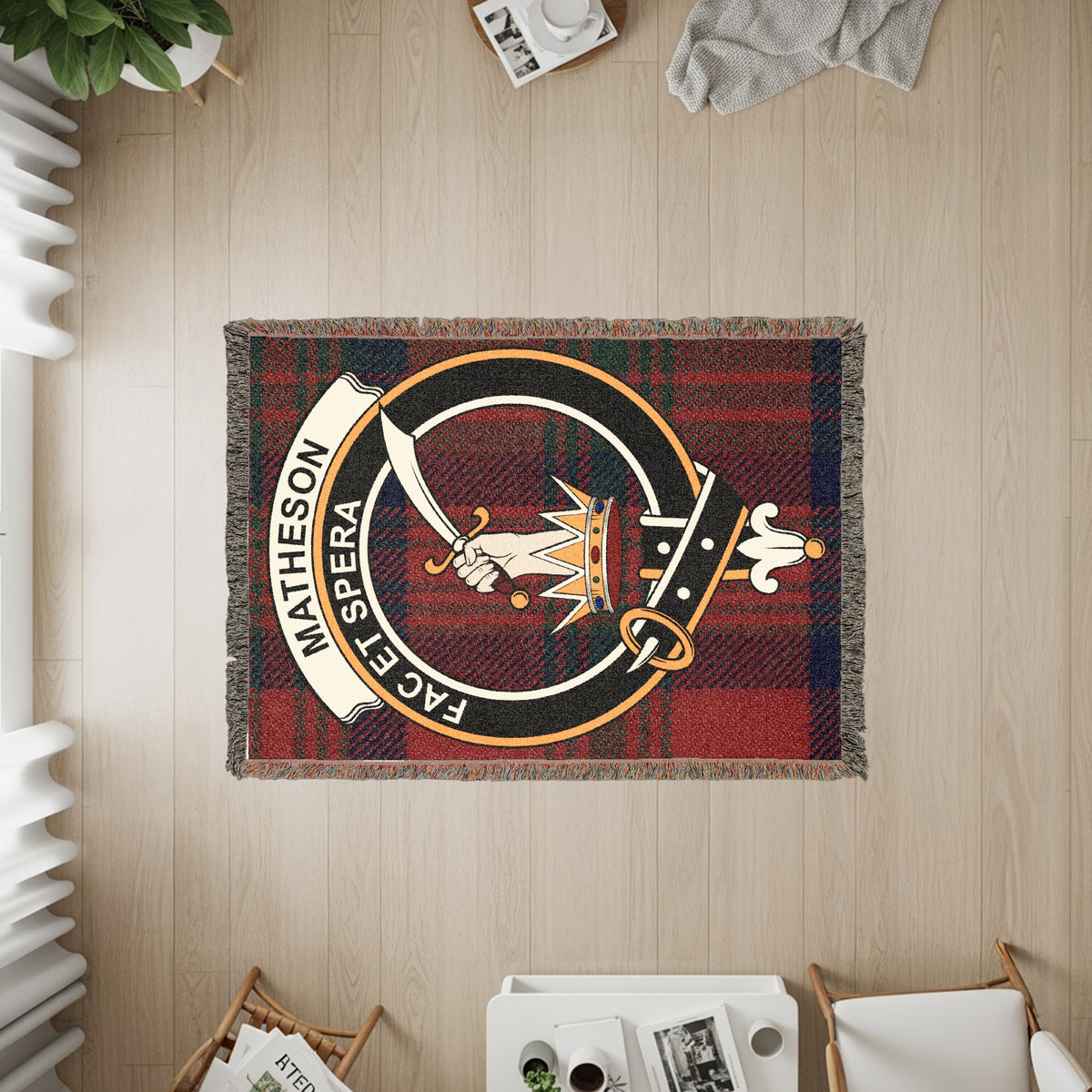 Matheson woven blanket displayed on a wall, featuring the crest badge and tartan background