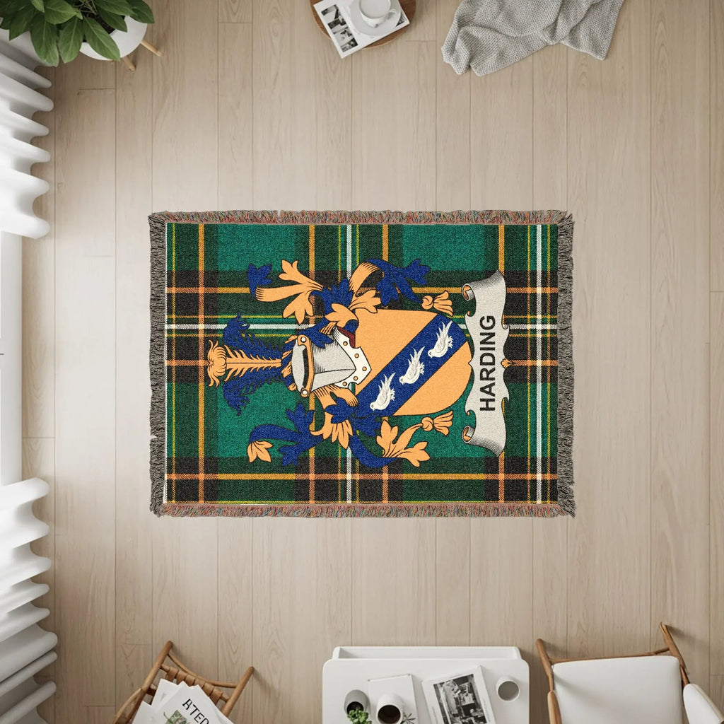 Harding family crest on a green plaid woven throw blanket.