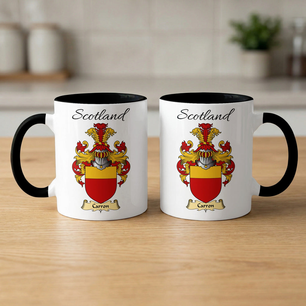 Pair of black-accent Carron mugs showing the double-sided Scottish family shield design on white ceramic.
