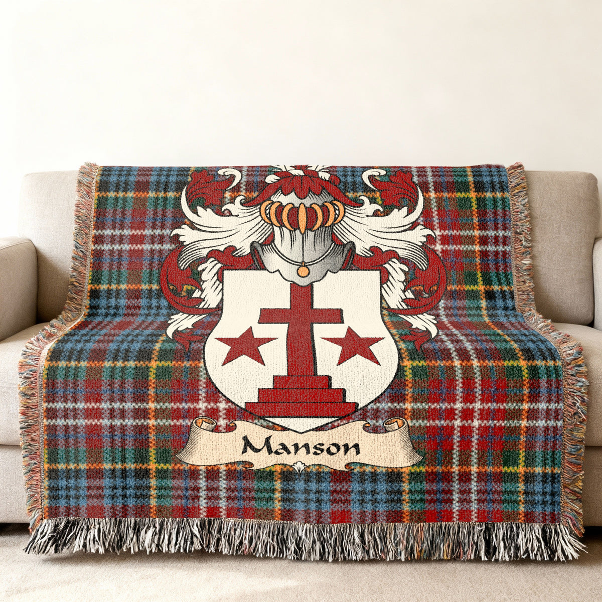 Manson family crest emblem on a Caledonia tartan woven blanket