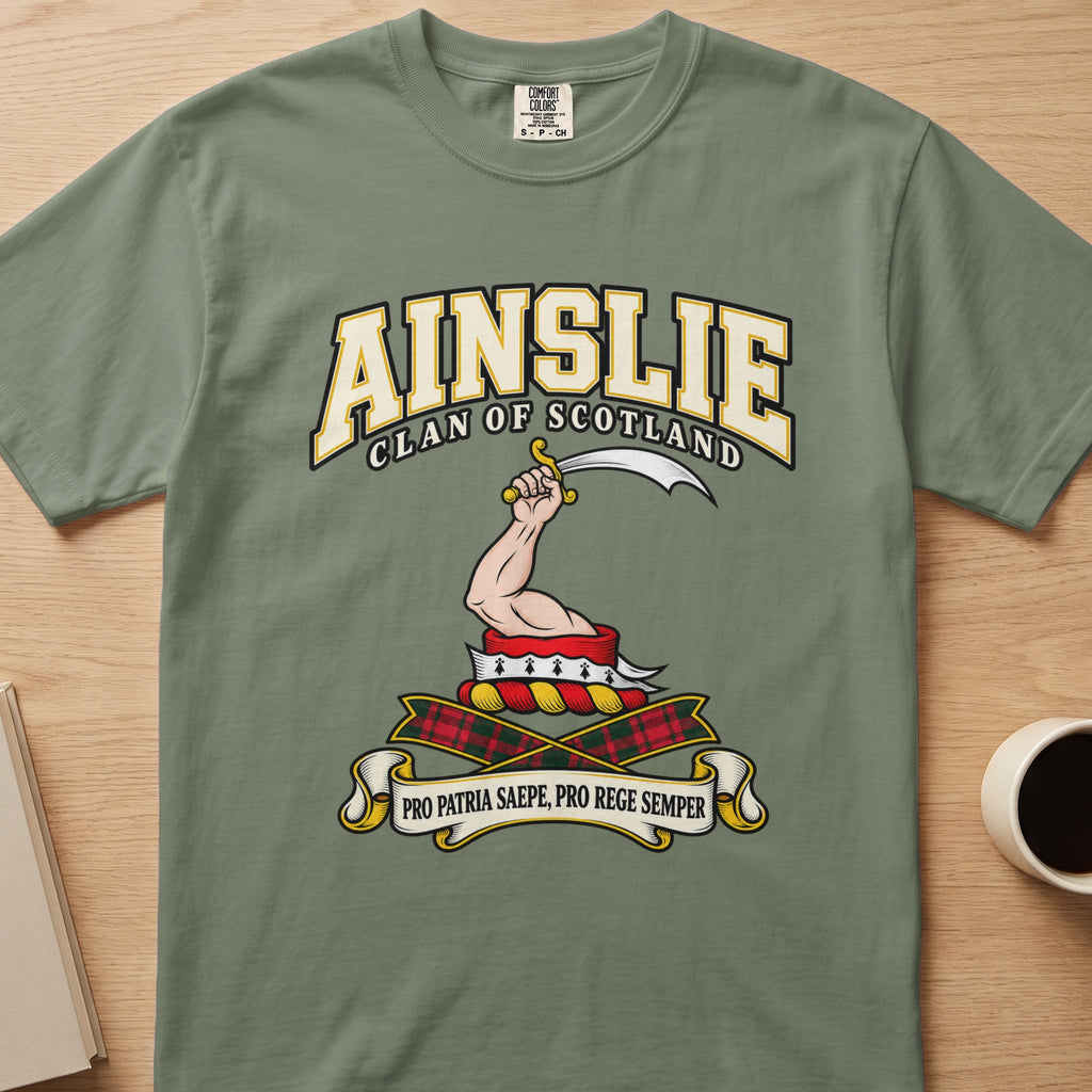 Ainslie raised arm with curved blade graphic on a sage green Comfort Colors T-shirt, front view
