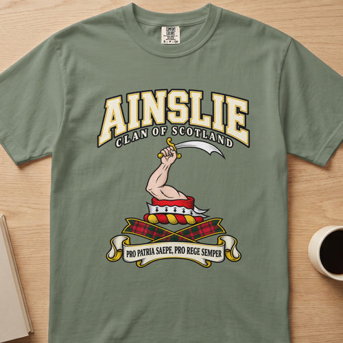 Ainslie raised arm with curved blade graphic on a sage green Comfort Colors T-shirt, front view