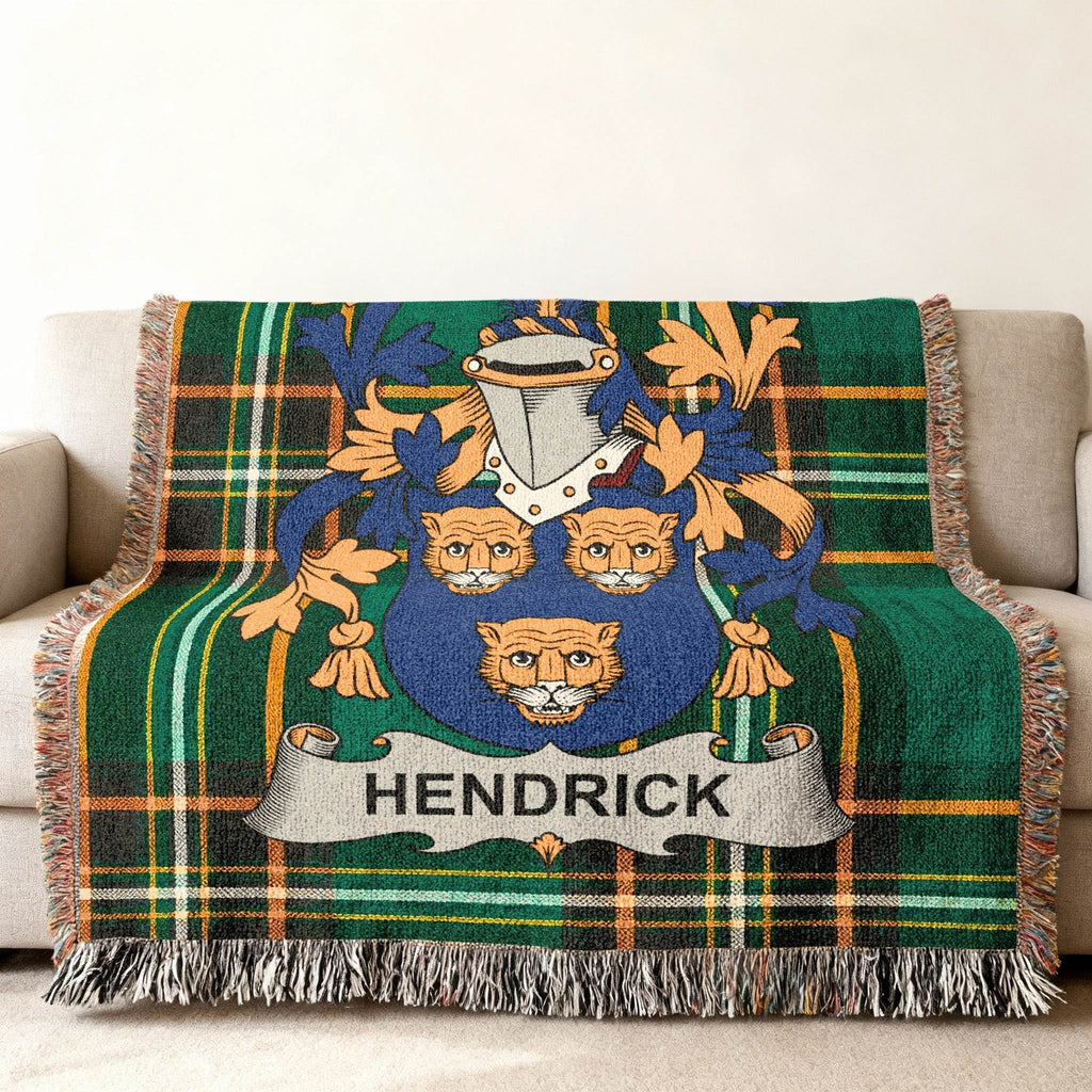 Woven blanket featuring the Hendrick family crest on a green plaid background.