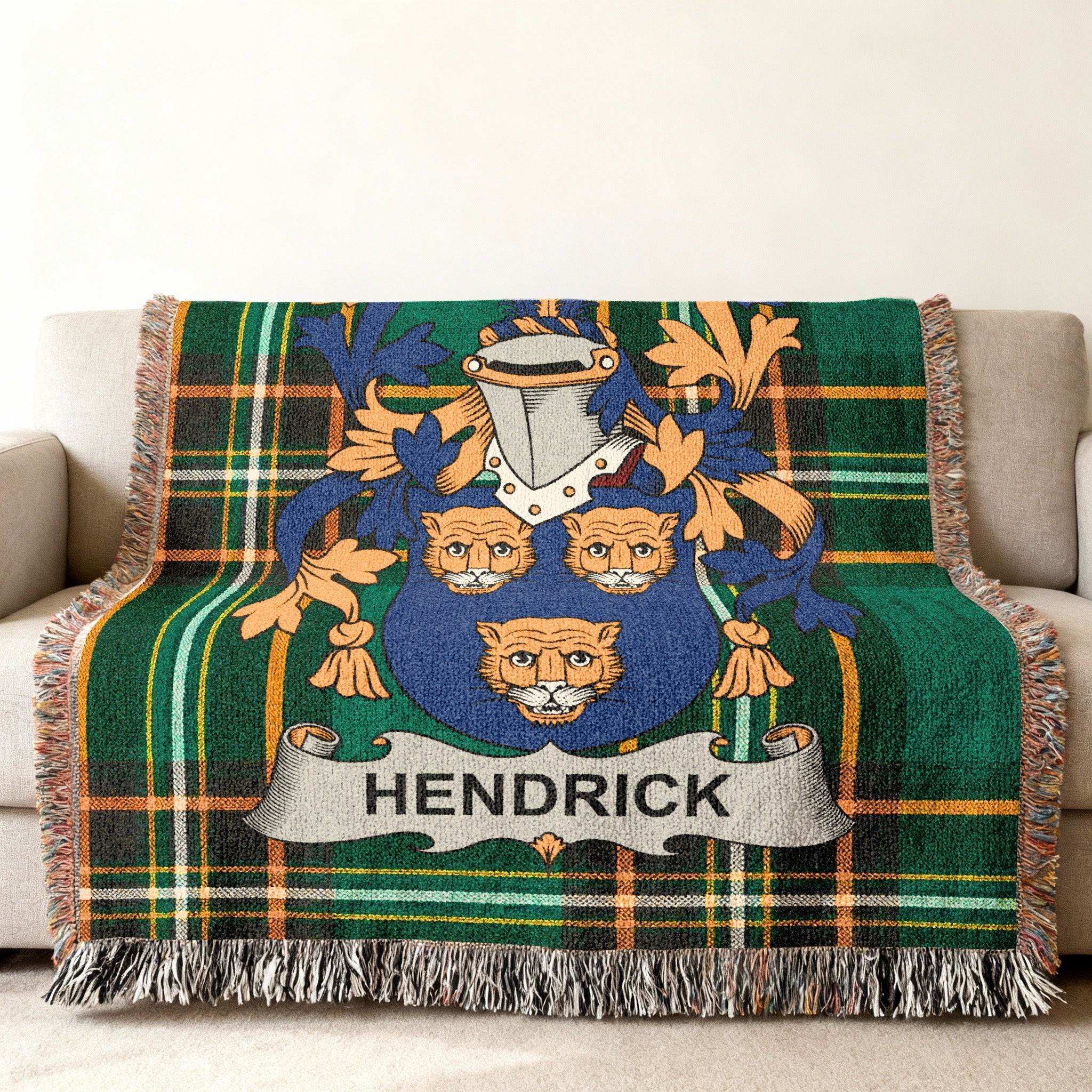 Woven blanket featuring the Hendrick family crest on a green plaid background.