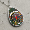 Logan clan Scottish tartan necklace with clan crest and Hoc Majorum Virtus motto on tartan background