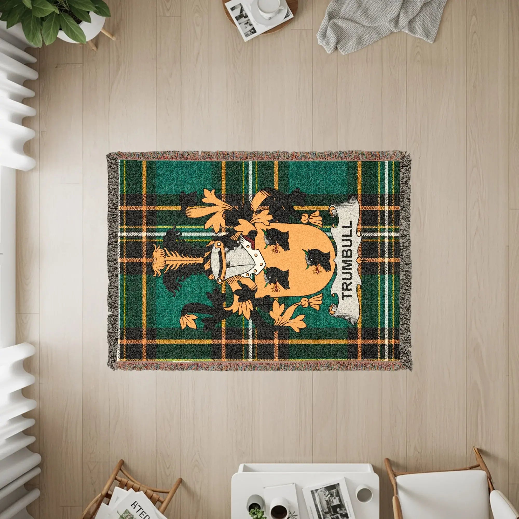 Woven blanket featuring the Trumbull tartan and crest in green, yellow, and black.