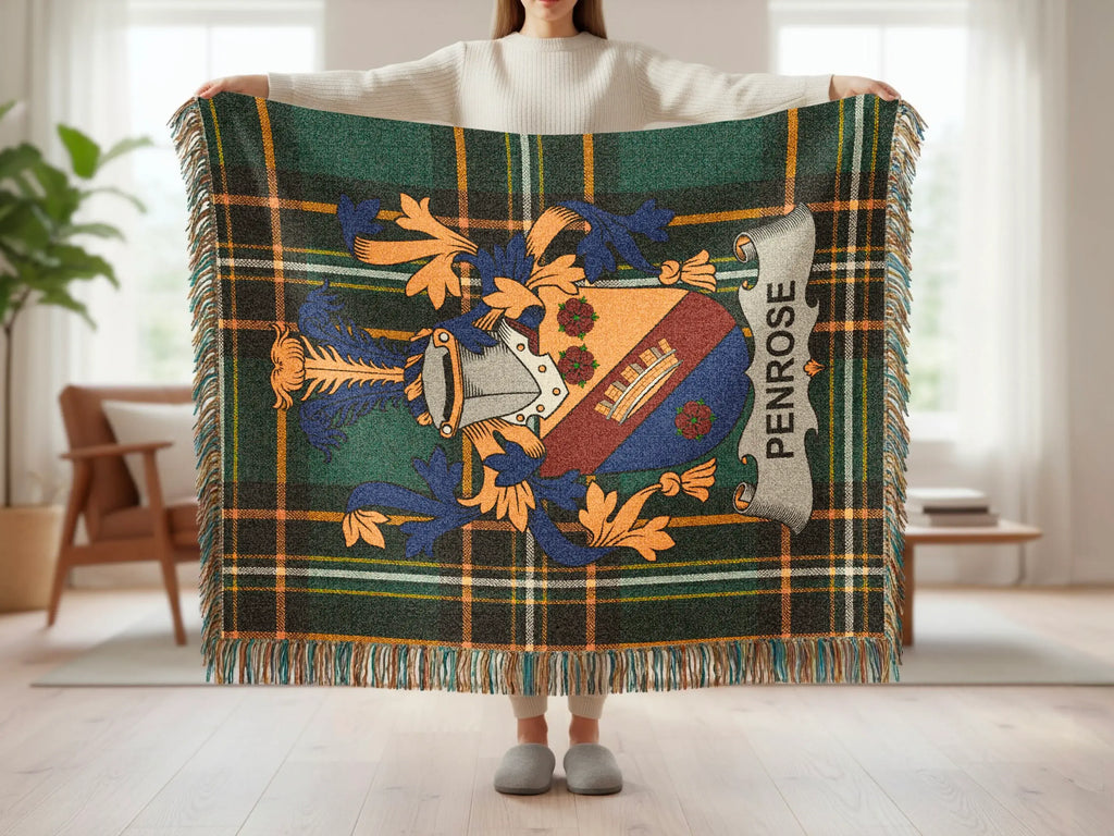 Tartan blanket with Penrose coat of arms and fringe, held by a person.
