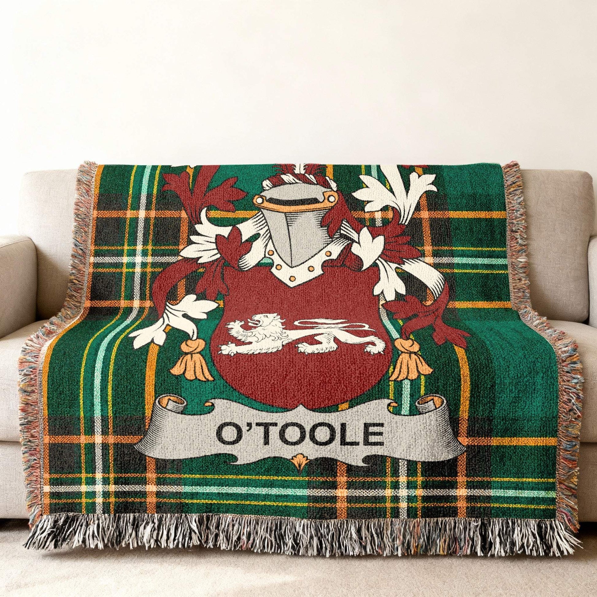 Green tartan throw blanket with O'Toole family crest and lion.