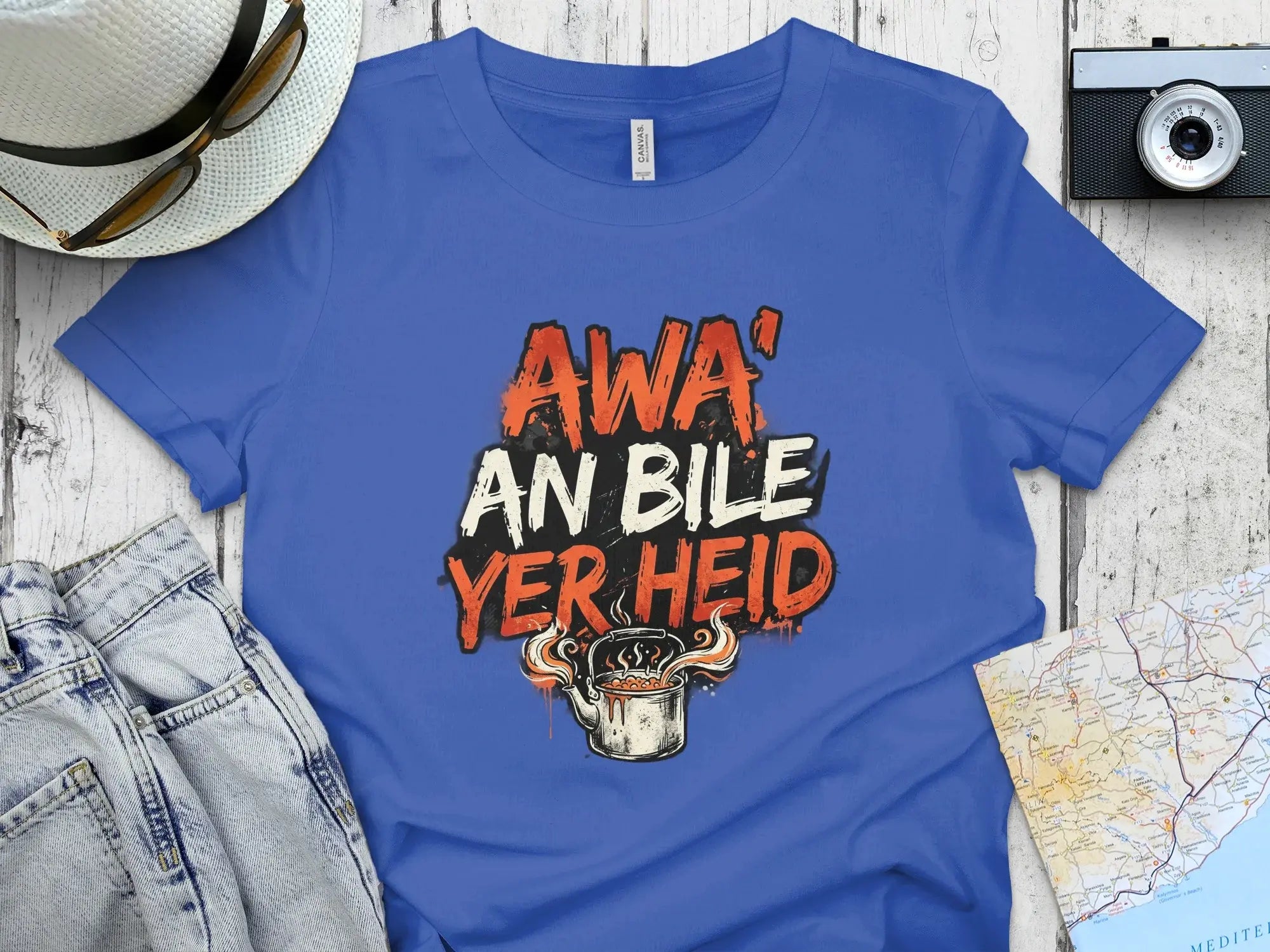 Blue t-shirt with "Awa' an bile yer heid" text and steaming cup graphic.