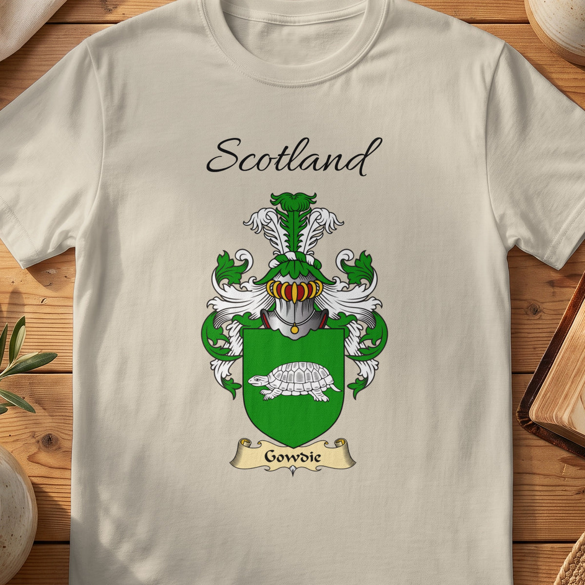 Sand Gowdie Scottish family shield T-shirt featuring a pale tortoise on a green shield