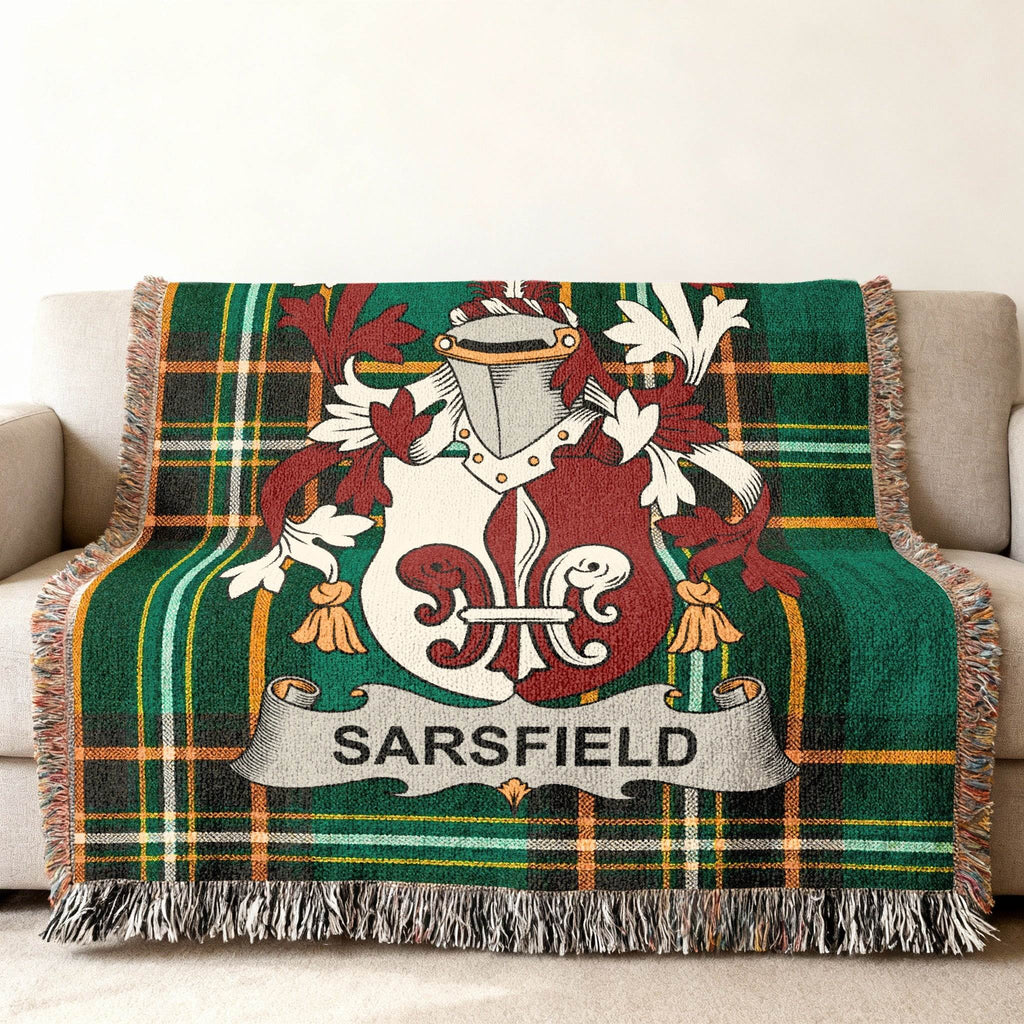 Woven throw blanket with green tartan and Sarsfield family crest.