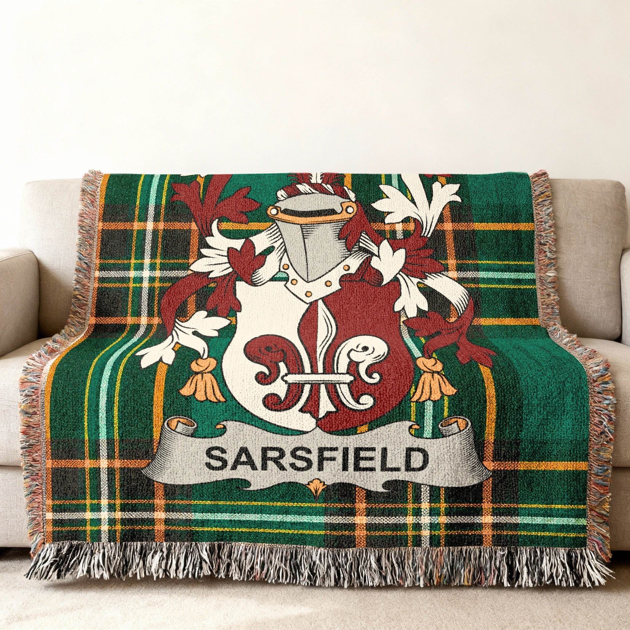 Woven throw blanket with green tartan and Sarsfield family crest.