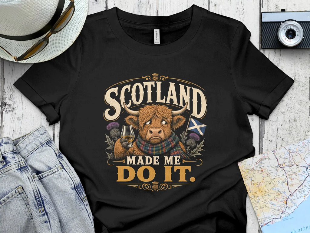 T-shirt with a Highland cow wearing a plaid scarf, holding a whiskey glass.