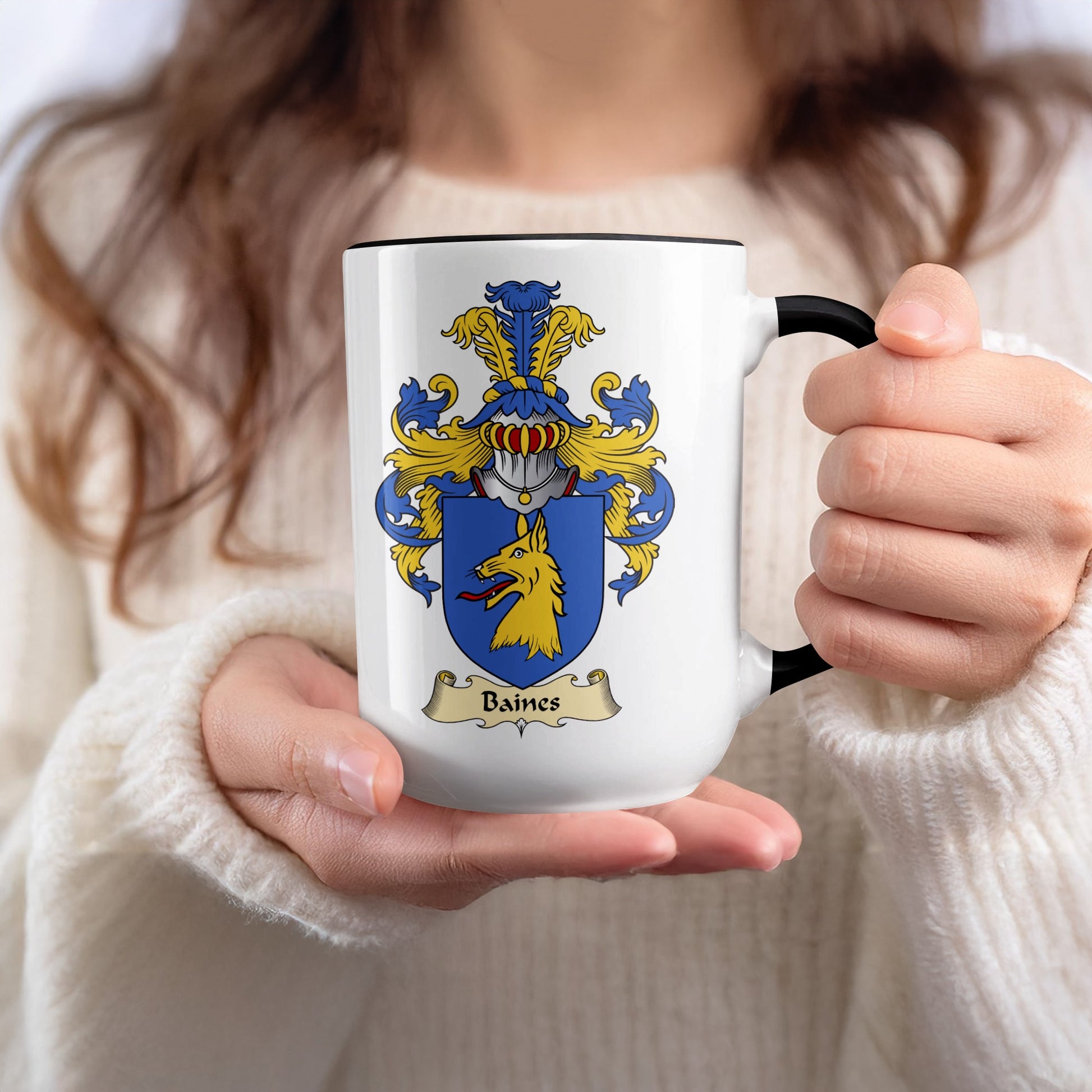 White mug with black rim featuring a coat of arms and "Baines" text.