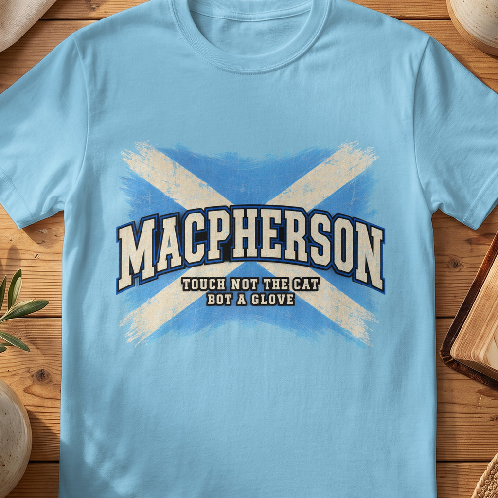MacPherson Scottish Saltire T-shirt in Sky, with distressed blue and cream flag and “Touch Not the Cat Bot a Glove” lettering.