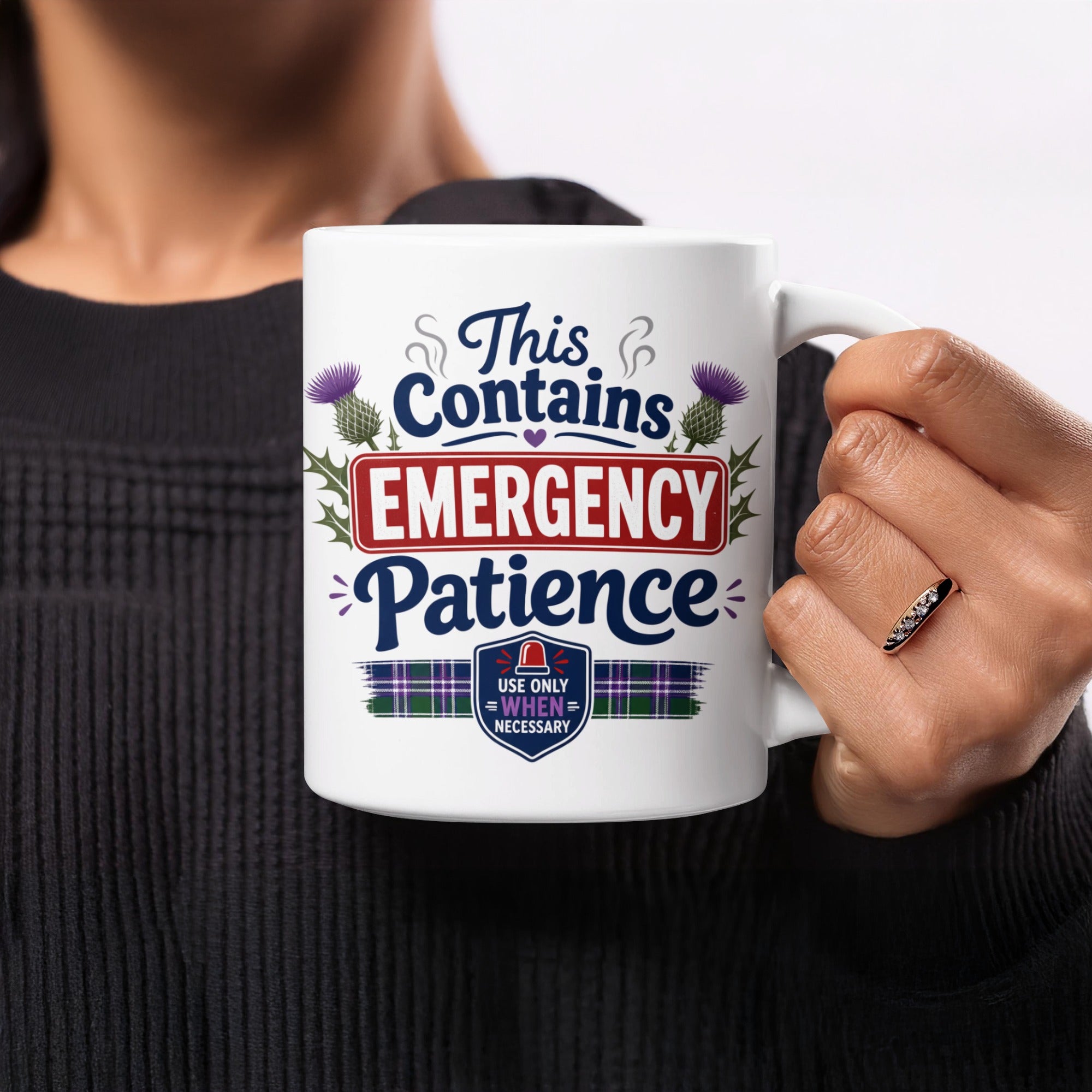White mug with "This Contains EMERGENCY PATIENCE" and tartan accents.