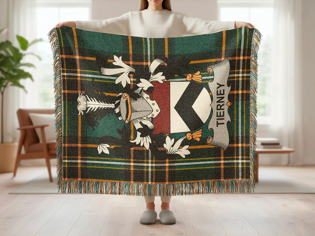 Tartan blanket with a shield crest bearing "TIERNEY" held by a person.