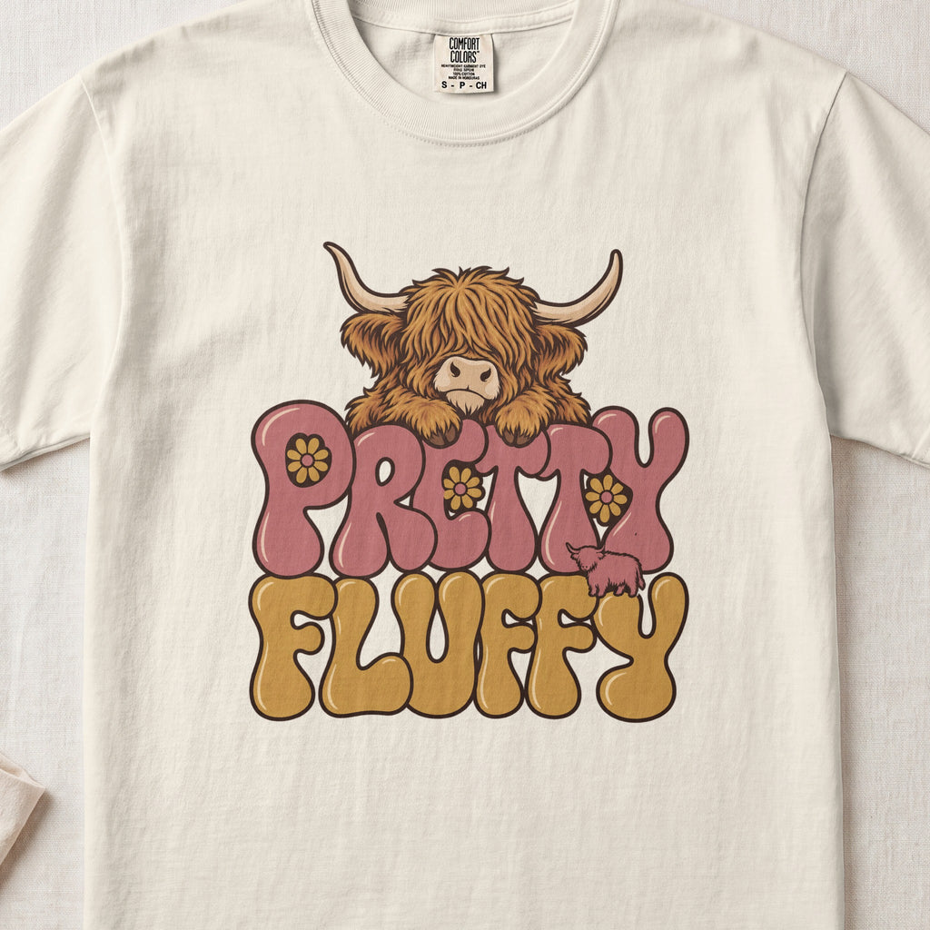 Pretty Fluffy Highland cow design on an Ivory Comfort Colors 1717 T-shirt, flat lay
