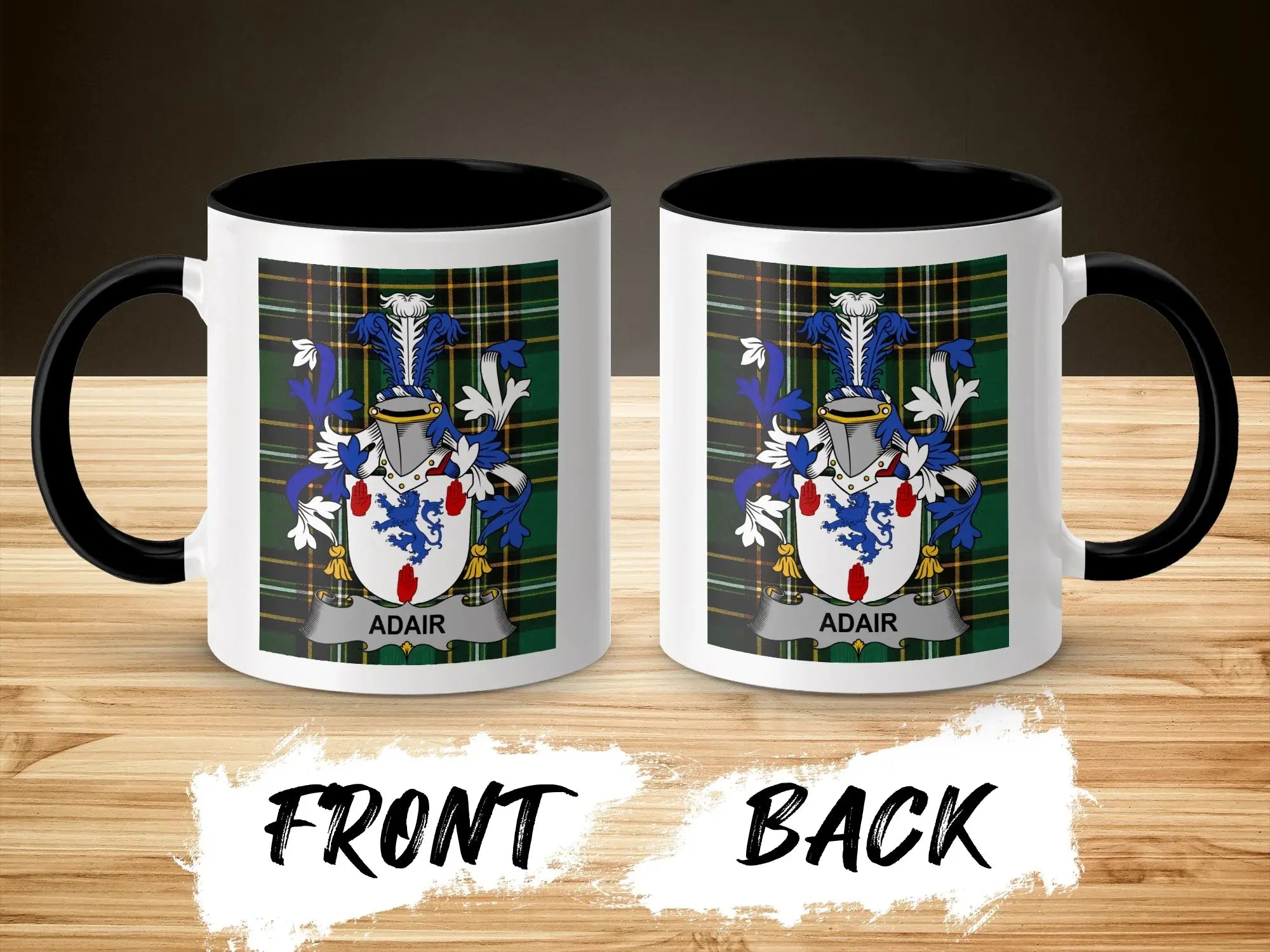 Two mugs with the Adair family crest and plaid design on a wooden surface.