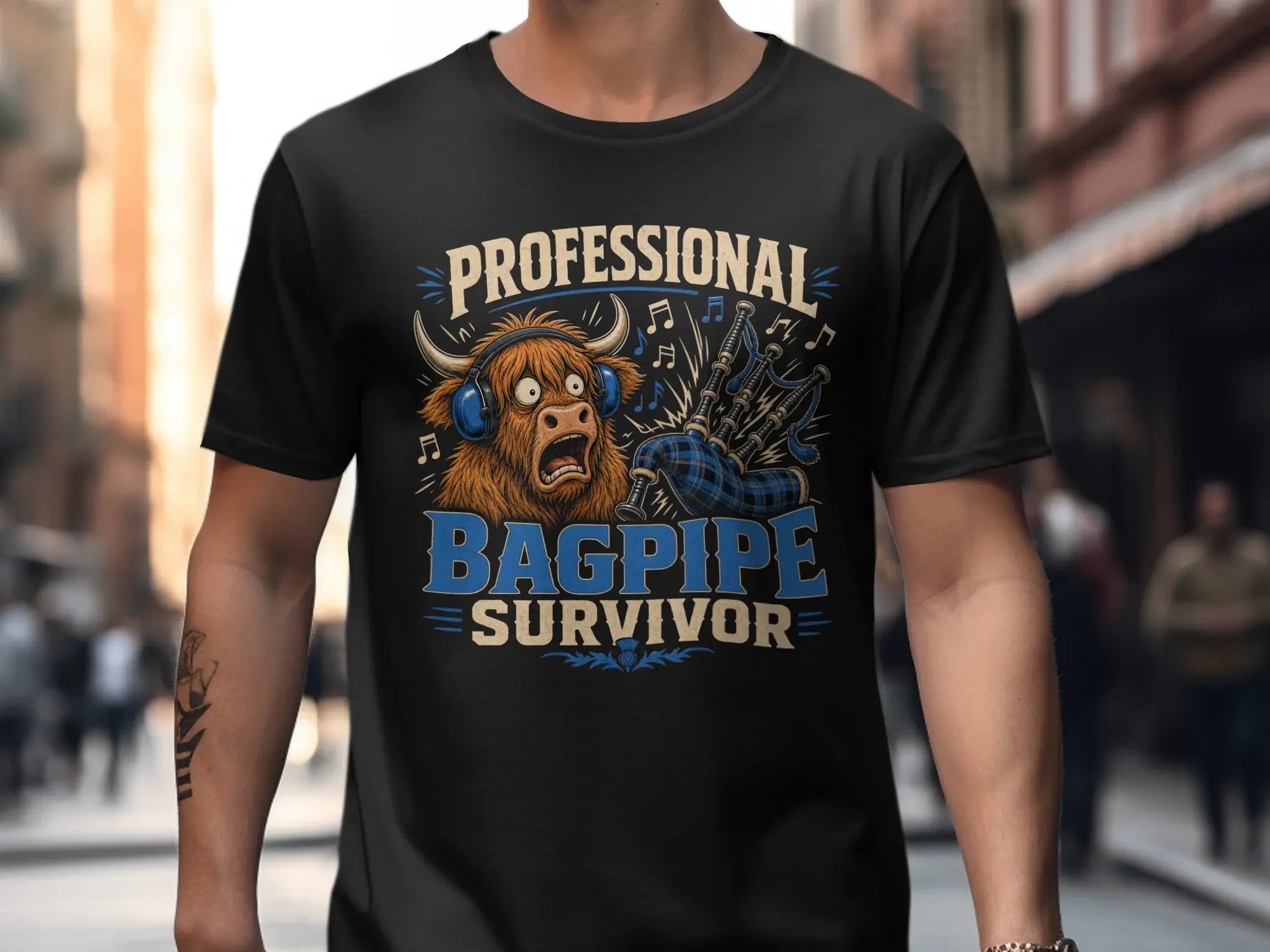 Black t-shirt with "Professional Bagpipe Survivor" text and cartoon Highland cow.