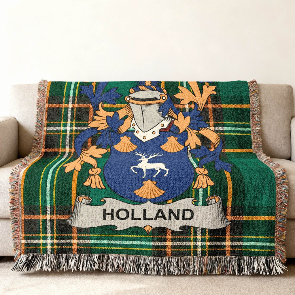 Woven blanket with green plaid and a blue and gold family crest reading "HOLLAND".