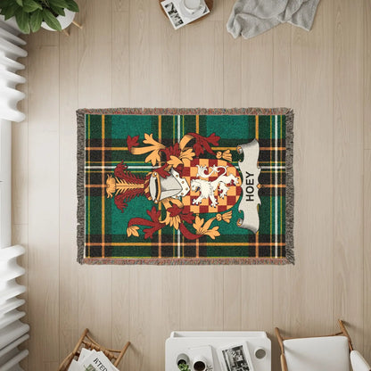 Green plaid woven blanket with a family crest and the name HOEY.